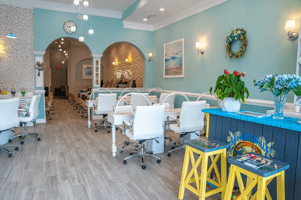 The front desk and manicure tables at Pacific Nail Spa, with arched doorways behind